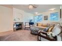 Cozy living room featuring a decorative fireplace, neutral color palette, and comfortable furnishings at 9050 Warm Springs Rd # 2050, Las Vegas, NV 89148