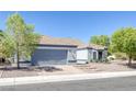 Charming one-story home featuring a two-car garage, desert landscaping, and a traditional roof at 9100 Shelter Cove Ct, Las Vegas, NV 89117