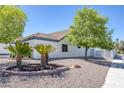 A charming house with well-maintained desert landscaping, featuring palm trees and gravel groundcover at 9100 Shelter Cove Ct, Las Vegas, NV 89117