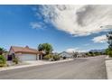 Single-story house featuring desert landscaping, tile roofing, and an attached two-car garage at 9337 Quail Ridge Dr, Las Vegas, NV 89134