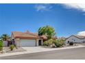 View of single-story home with a tile roof, attached garage, and desert landscaping at 9337 Quail Ridge Dr, Las Vegas, NV 89134