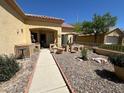 Charming front yard with desert landscaping, rock features, and a cozy seating area at 9816 Villa Ridge Dr, Las Vegas, NV 89134
