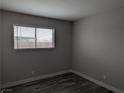 Bright bedroom with wood-look flooring and natural light from window at 1220 Toledo St, Henderson, NV 89015