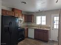 Well-lit kitchen featuring wood cabinets, stainless steel appliances, and a practical layout at 1220 Toledo St, Henderson, NV 89015