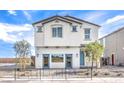 Inviting two-story house featuring light stucco, a tiled roof, and desert landscaping at 1289 Miller Springs Ln # 96, North Las Vegas, NV 89084