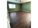 Spacious bedroom with modern ceiling fan and new laminate flooring at 1941 Golden Trumpet Ave, Las Vegas, NV 89123