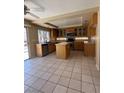 Charming kitchen with island, stainless steel appliances, and tile flooring at 1941 Golden Trumpet Ave, Las Vegas, NV 89123