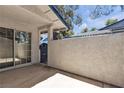 Outdoor patio area featuring textured wall, tile roofline, and entry gate at 2124 Willowbury Dr # D, Las Vegas, NV 89108
