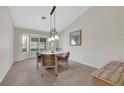 Cozy dining room featuring a bay window, carpeted floor, and stylish chandelier, perfect for Gathering meals at 2216 Sapphire Valley St, Las Vegas, NV 89128
