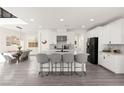 Open-concept kitchen with large island, modern appliances, and adjacent dining area at 3058 Casarano Ct, Henderson, NV 89044