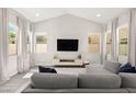 Spacious living room with vaulted ceilings, ample natural light, and stylish decor at 3058 Casarano Ct, Henderson, NV 89044