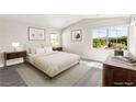 Serene main bedroom with large windows offering scenic views, and comfortable furnishings at 3058 Casarano Ct, Henderson, NV 89044