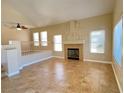 Open living room featuring a fireplace, vaulted ceiling, and neutral colors at 3679 Funston Way, Las Vegas, NV 89129