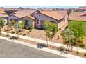 Charming single-story home featuring manicured landscaping and a brick driveway at 369 Old Erie Pl, Henderson, NV 89011
