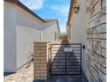 Private side yard entrance featuring a metal gate with no soliciting sign at 369 Old Erie Pl, Henderson, NV 89011