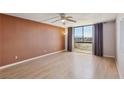Bright living room with wood floors and floor-to-ceiling windows at 3930 University Center Dr # 804, Las Vegas, NV 89119