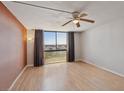 Large, open living room with floor-to-ceiling windows and contemporary light fixture at 3930 University Center Dr # 804, Las Vegas, NV 89119