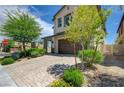 Beautiful two-story home with a desert landscape, a paved driveway, and a spacious two-car garage at 3949 Amanda Bay Ave, North Las Vegas, NV 89081
