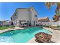 Inviting pool surrounded by a patio and lush landscaping creates a perfect backyard oasis at 5612 Royal Castle Ln, Las Vegas, NV 89130