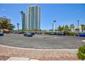 View of a spacious parking lot with city buildings in the background at 572 Tam O Shanter, Las Vegas, NV 89109