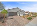 Charming single-Gathering home featuring a 2-car garage and stylish stone driveway at 605 Cadence Vista Dr, Henderson, NV 89011