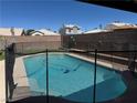 Sparkling backyard pool offering a refreshing escape, enclosed with a safety fence for peace of mind at 6363 Berry Patch Way, Las Vegas, NV 89142