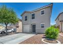 The exterior showcases desert landscaping and a neutral color scheme, complemented by the blue sky at 6377 W Haleh Ave, Las Vegas, NV 89141