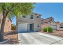 Daytime image of a two-story home with desert landscaping and a concrete driveway under a clear sky at 6377 W Haleh Ave, Las Vegas, NV 89141