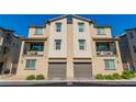 Attractive two-story townhome features a modern design with a private balcony and a garage at 6953 Midnight Bronze St, North Las Vegas, NV 89086