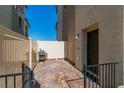 Cozy outdoor patio includes stylish brick pavers, a barbecue grill, and privacy fencing at 6953 Midnight Bronze St, North Las Vegas, NV 89086