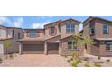 Charming two-story home with a two-car garage, stone accents, and a beautifully landscaped front yard at 769 Cloud Creek St, Henderson, NV 89011