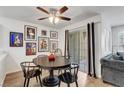 Cozy dining area with art, a modern ceiling fan, and sliding glass doors for bright light and easy access at 7950 W Flamingo Rd # 1042, Las Vegas, NV 89147