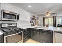 Bright kitchen features two-tone cabinets, stainless steel appliances, and a view of the attached dining area at 7950 W Flamingo Rd # 1042, Las Vegas, NV 89147