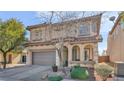 Well-maintained home with a two-car garage, tiled roof, manicured front yard, and an inviting arched entrance at 8139 Skytop Ledge Ave, Las Vegas, NV 89178