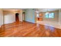 Open-concept living space featuring hardwood floors connecting to a bright kitchen at 8729 Pesaro Dr, Las Vegas, NV 89117