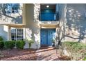 Stylish townhome featuring a private balcony, a blue door, and meticulous landscaping at 882 Tam O Shanter, Las Vegas, NV 89109
