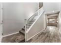 Bright entryway features wood-look flooring that leads to the staircase with white risers and light gray carpet at 9850 Poplar Point Ave, Las Vegas, NV 89178