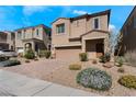 Inviting two-story home features a two-car garage, manicured landscaping, and a covered front porch entry at 9850 Poplar Point Ave, Las Vegas, NV 89178
