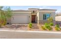 Charming single-story home featuring stone accents, a brick driveway, and a two-car garage at 10160 Tree Blossom Ave, Las Vegas, NV 89166