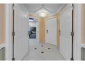 Bright hallway boasts a tile floor pattern with decorative accent, neutral paint and white doors and trim throughout at 145 E Harmon Ave # 3705, Las Vegas, NV 89109