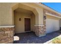 Inviting front porch features stone accents, providing a warm and welcoming entrance to the home at 145 Forest Crossing Ct, Las Vegas, NV 89148