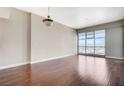 Spacious, naturally lit living room featuring hardwood floors and large windows with mountain views at 150 Las Vegas Blvd # 1716, Las Vegas, NV 89101