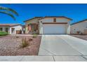 Charming single-story home with a well-manicured desert rock front yard and an attached two-car garage at 1604 Lazy Hill Ranch Way, North Las Vegas, NV 89081