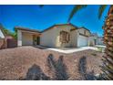 Charming single-story home with a well-manicured desert rock front yard and an attached two-car garage at 1604 Lazy Hill Ranch Way, North Las Vegas, NV 89081
