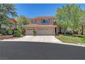 Charming two-story home with a three-car garage, desert landscaping, and a well-maintained lawn at 229 N Buteo Woods Ln, Las Vegas, NV 89144