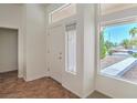 Bright entryway featuring tile floors, sidelight windows, and a white front door with decorative glass at 2413 Rockford St, Las Vegas, NV 89134
