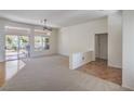 Spacious living room with carpeted floors, natural light, and a view of the backyard and patio at 2413 Rockford St, Las Vegas, NV 89134