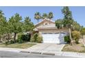 Inviting single-story home featuring a lush front lawn and a two-car garage at 2528 Huber Heights Dr, Las Vegas, NV 89128