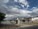 An exterior view of a single-story home from across the street under a cloudy sky at 2645 Cedar Ave, Las Vegas, NV 89101