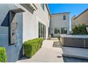 The backyard features a modern outdoor shower and a relaxing hot tub, perfect for unwinding after a long day at 2722 Marchetti Pl, Henderson, NV 89044